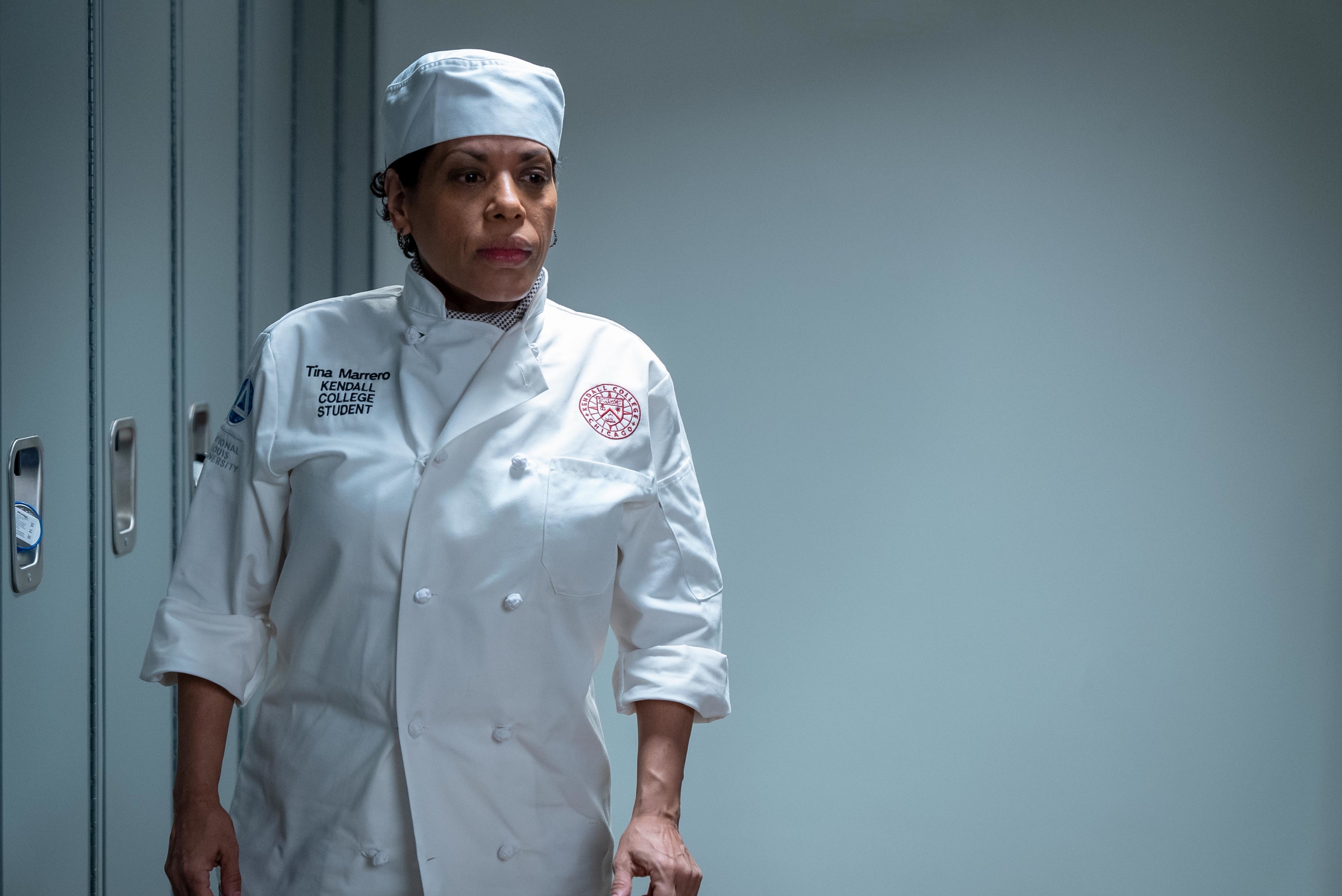 Liza Colón-Zayas wearing a chef&#x27;s coat and hat in The Bear