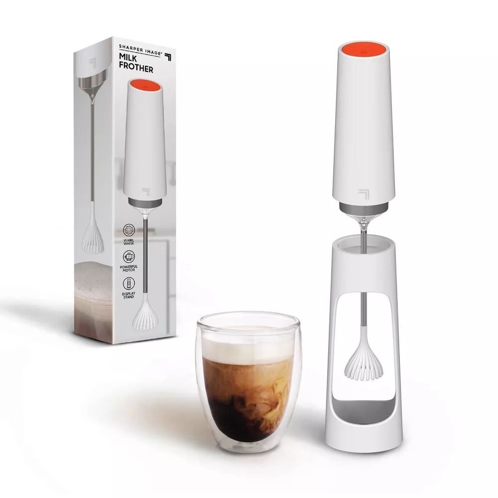 The milk frother shown next to a frothed coffee.