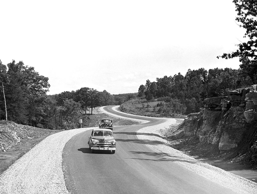 A car traveling through the Ozarks in the 1950s
