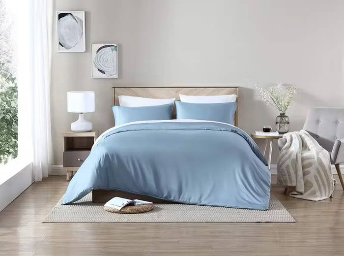the duvet covefr and matching pillowcases in denim on a bed