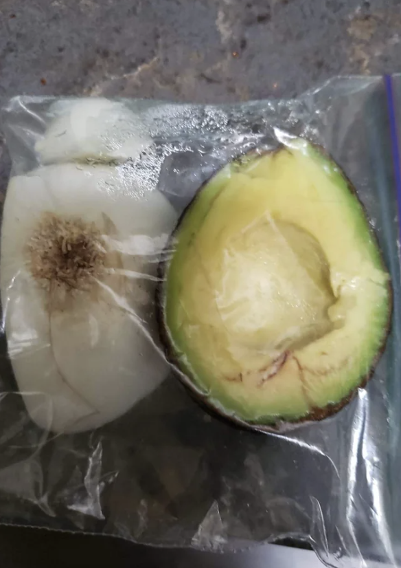 A cut onion and avocado in a baggie