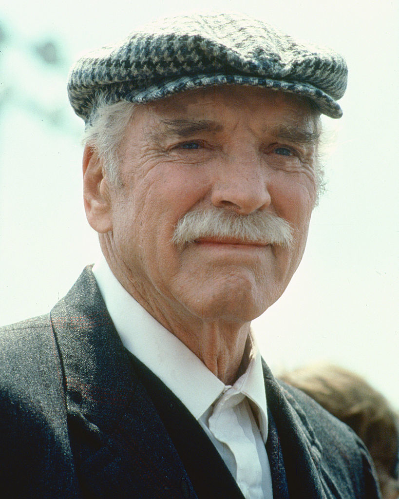 Lancaster wearing a flat cap in the film