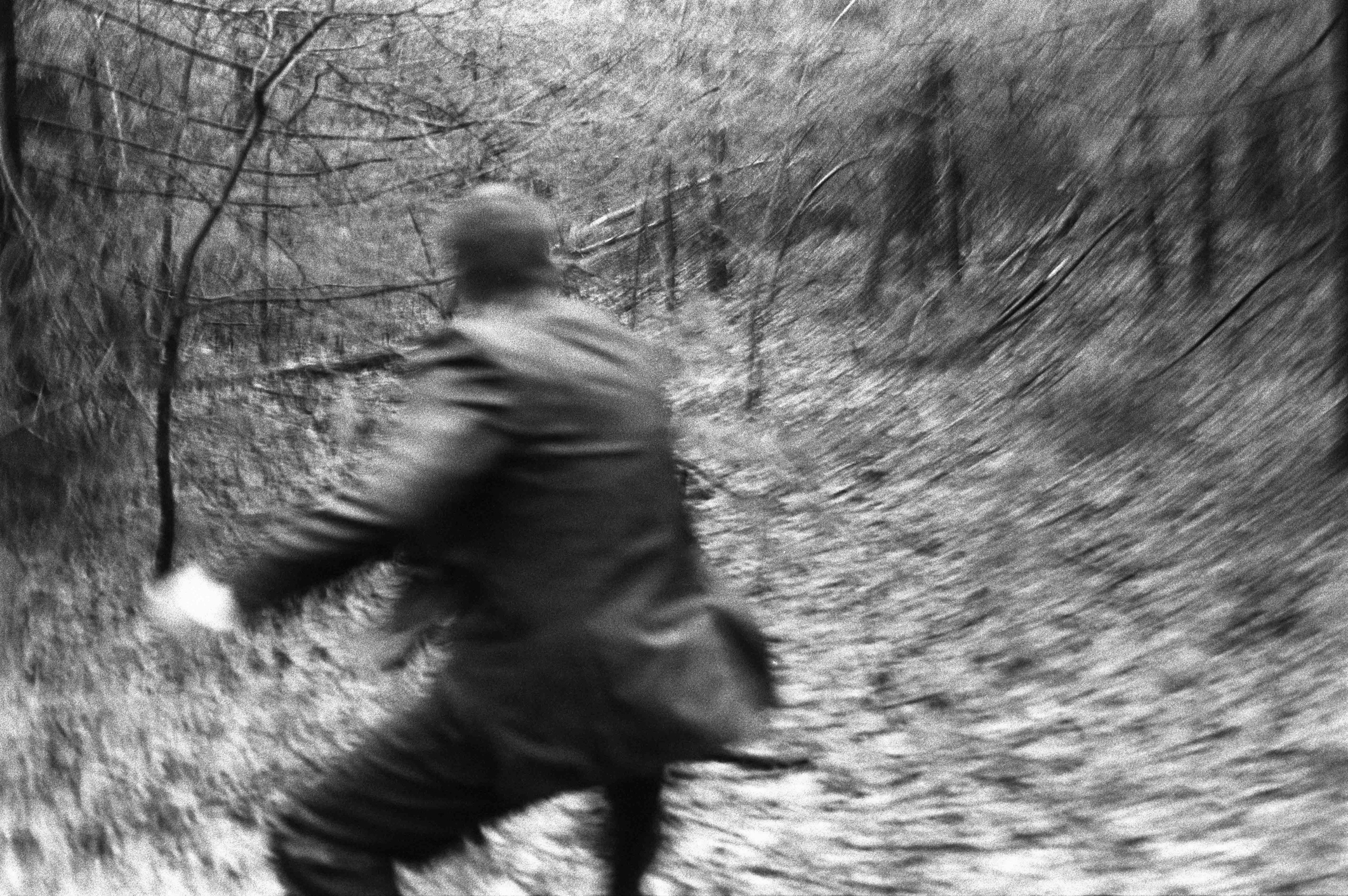 Man running or chasing something in the woods