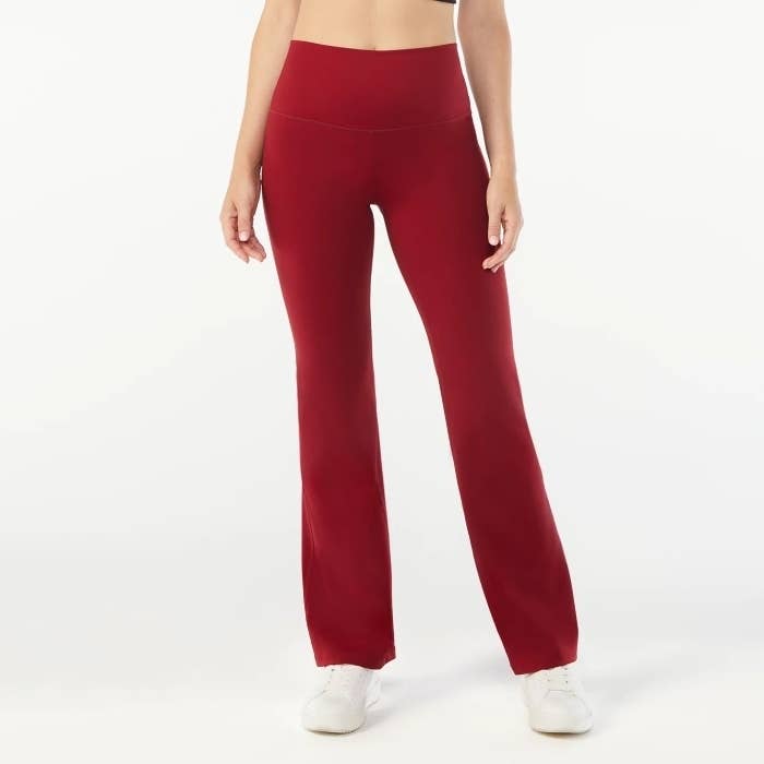 model wearing red wide leg yoga pants with white sneakers