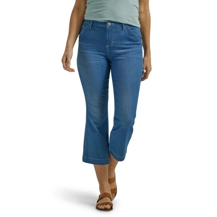 model wearing blue cropped pants and brown strappy sandals