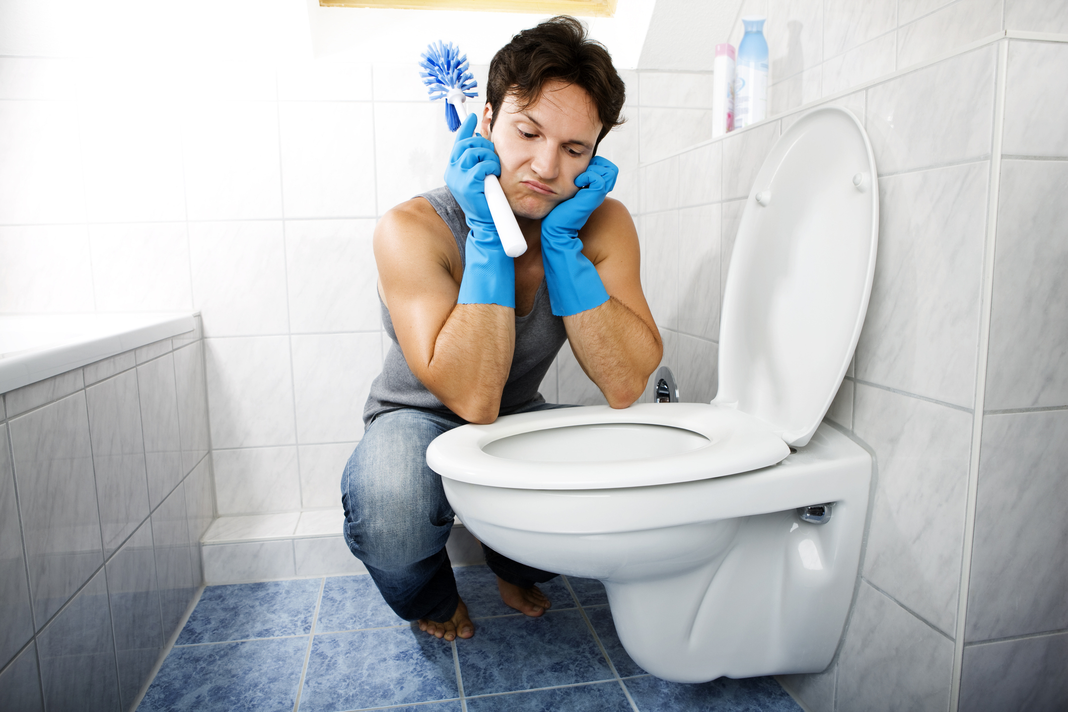man cleaning the toilet
