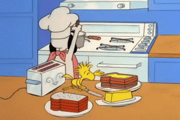 gif of snoopy and woodstock trying to make toast and burning snoopy&#x27;s ear