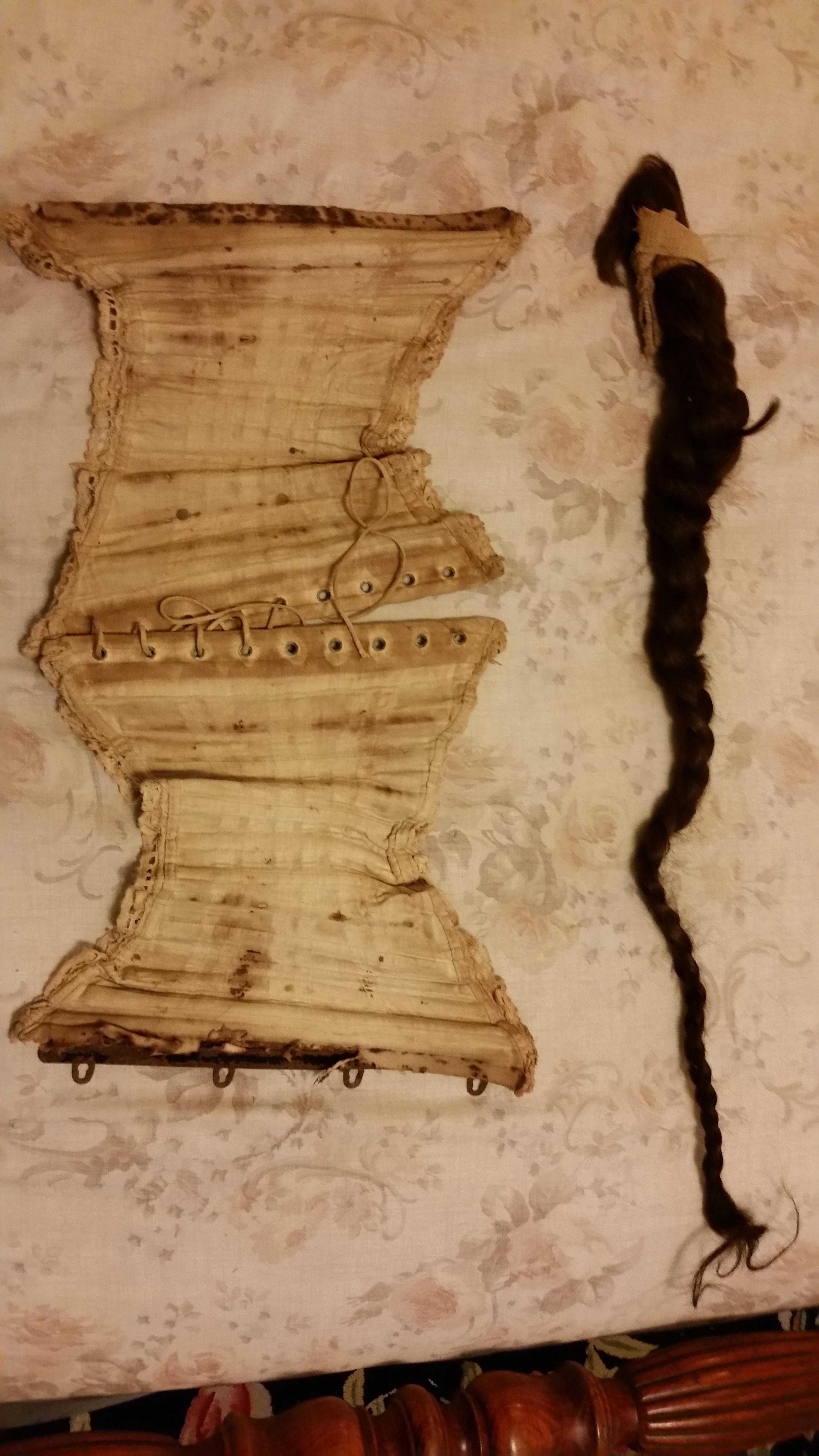 An old decaying corset and a long chopped braid