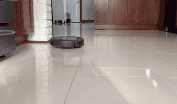 Reviewer&#x27;s Roomba moving across their kitchen floor
