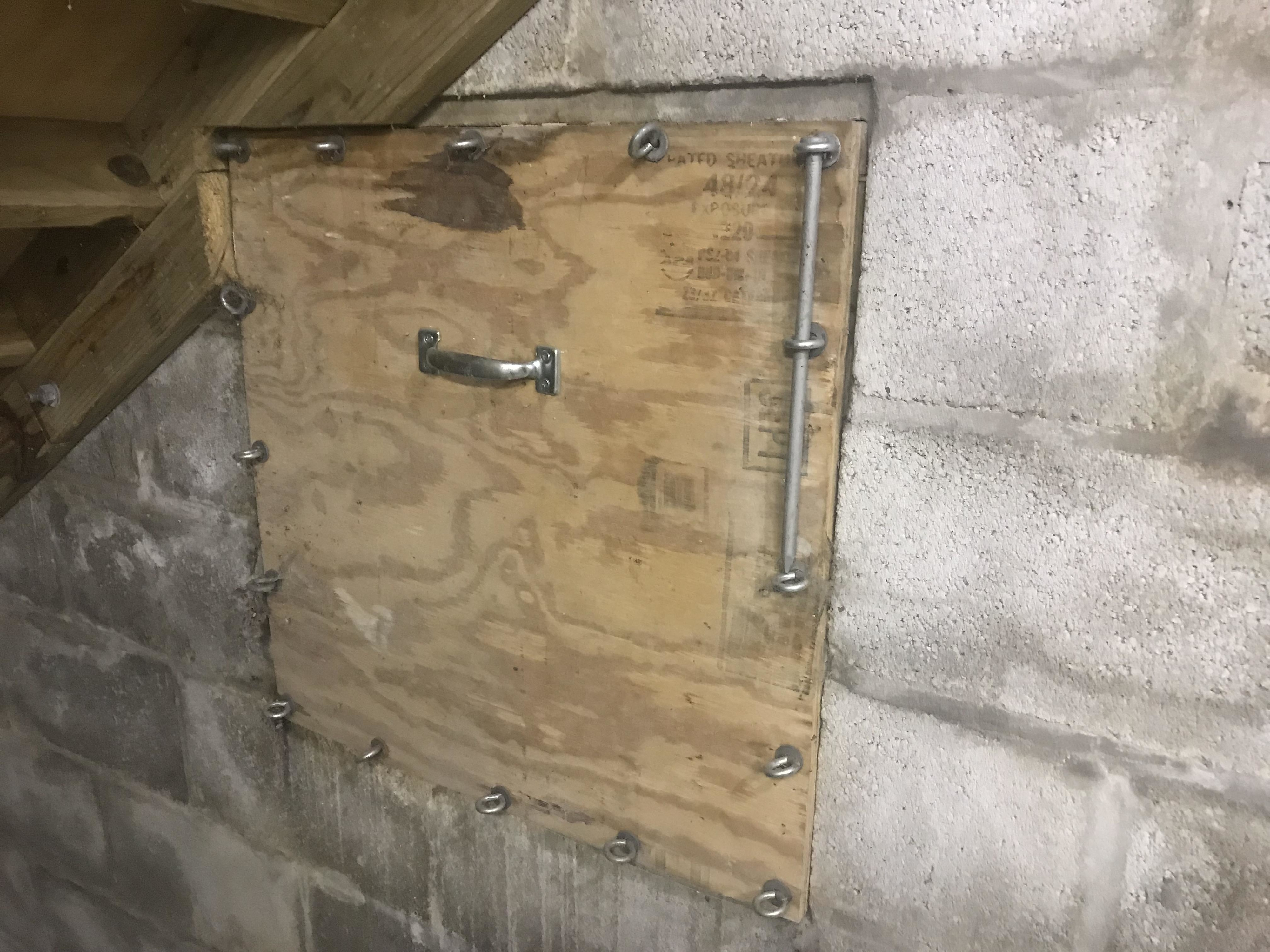 Hatch under the stairs that&#x27;s bolted into the wall and looks like a demon box