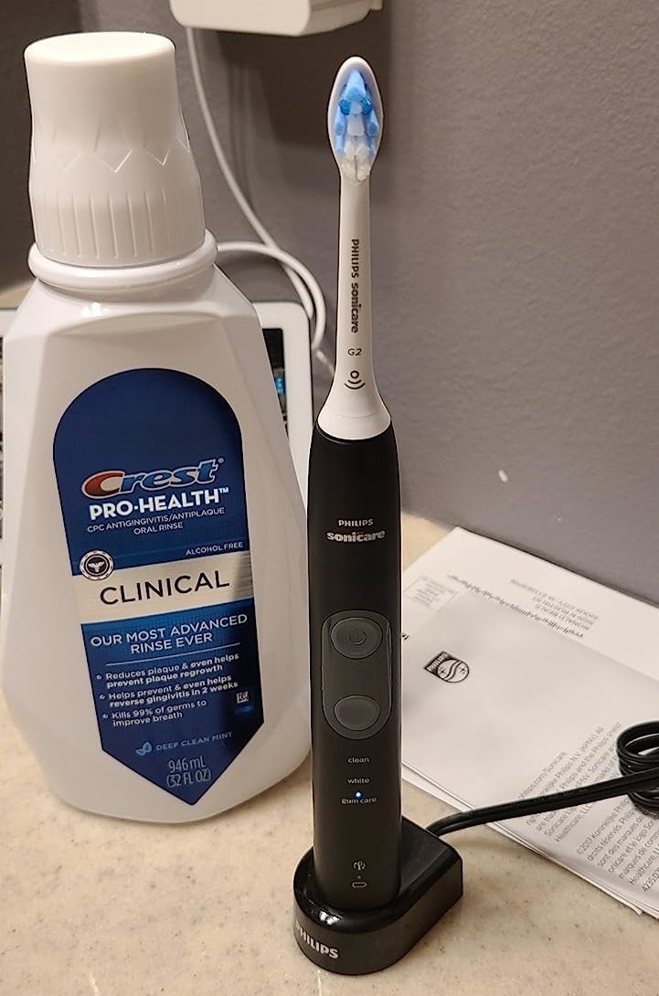 The toothbrush sitting on its charger