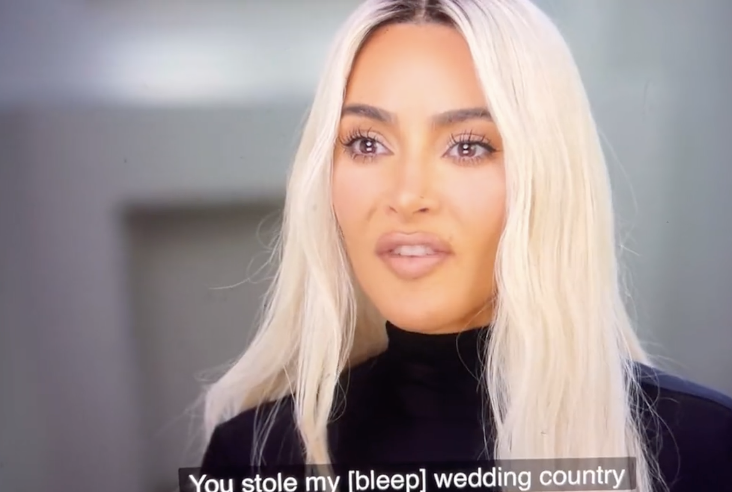 Close-up of Kim with long, platinum blonde hair with caption &quot;You stole my [bleep] wedding country&quot;