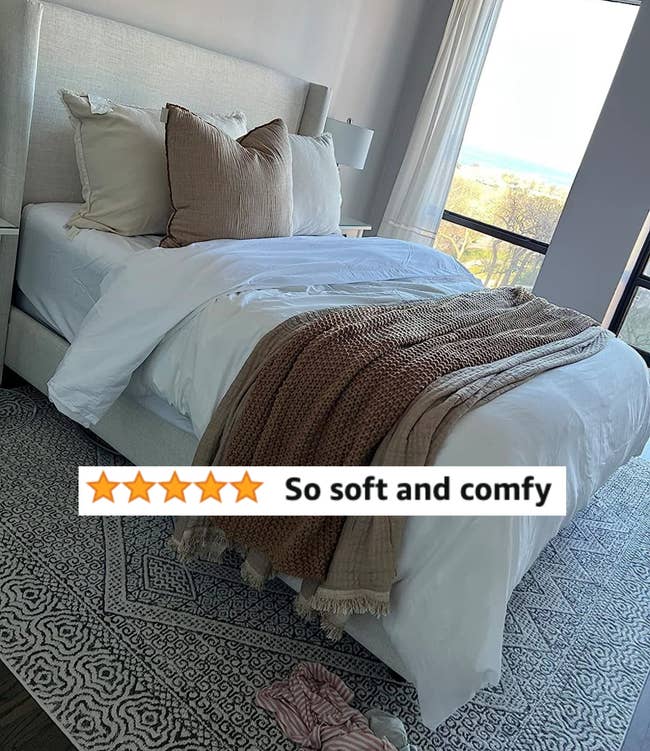A reviewers made bed with white sheets and review text 