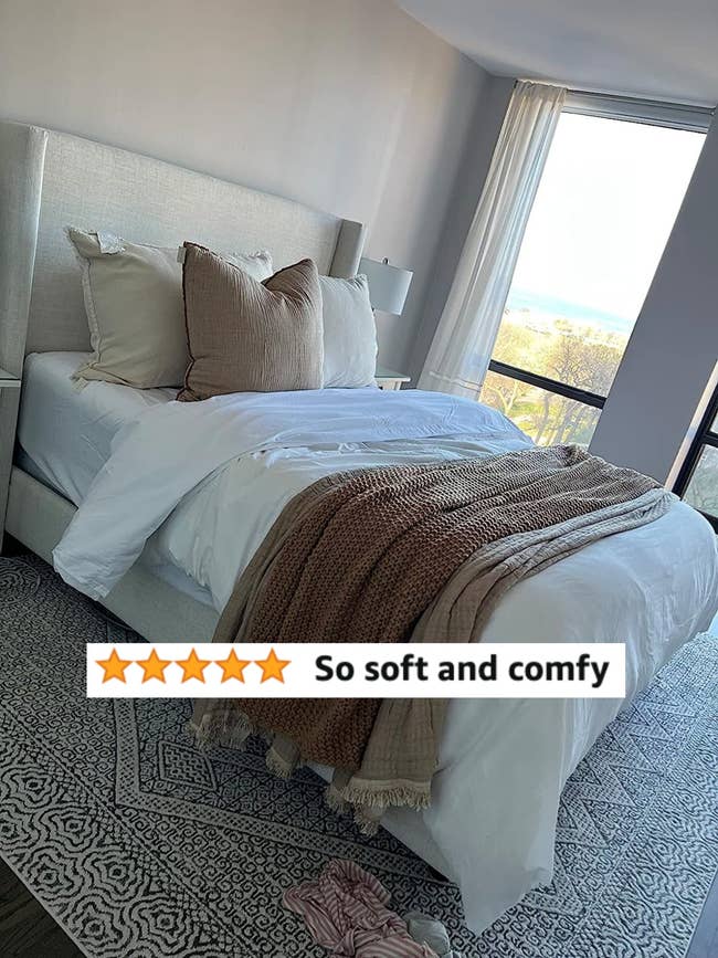 A reviewers made bed with white sheets and review text 