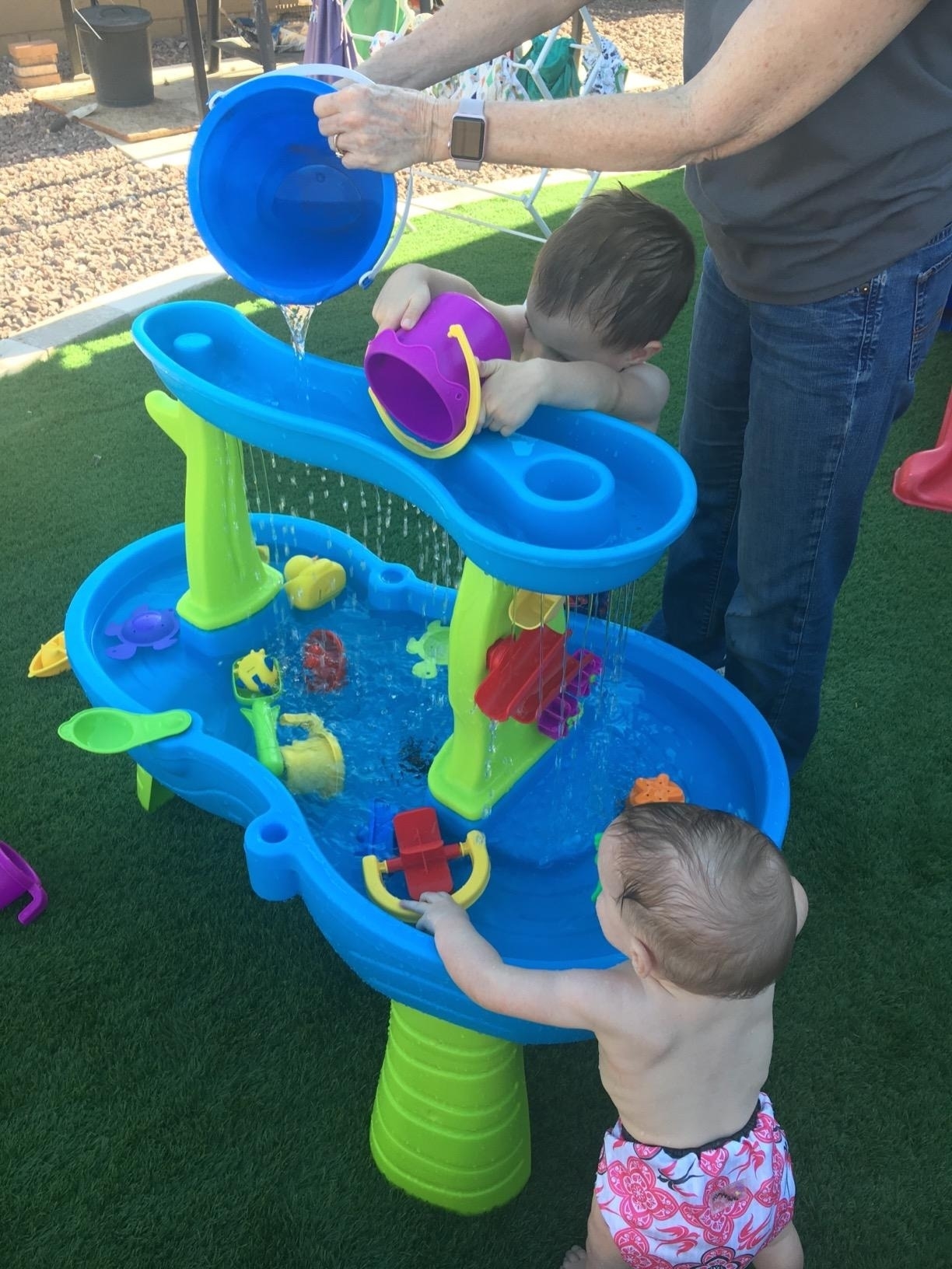 a reviewer photo of kids playing with the water table