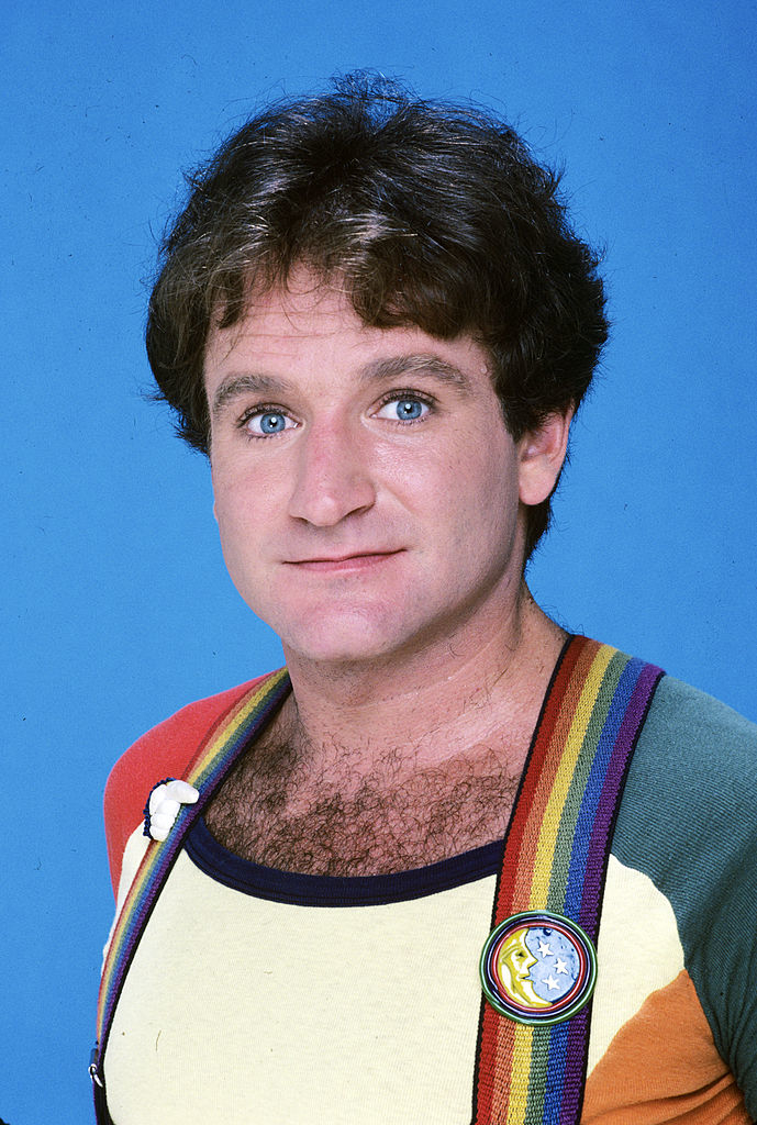 A headshot photo of Willias as Mork with his trademark rainbow suspenders