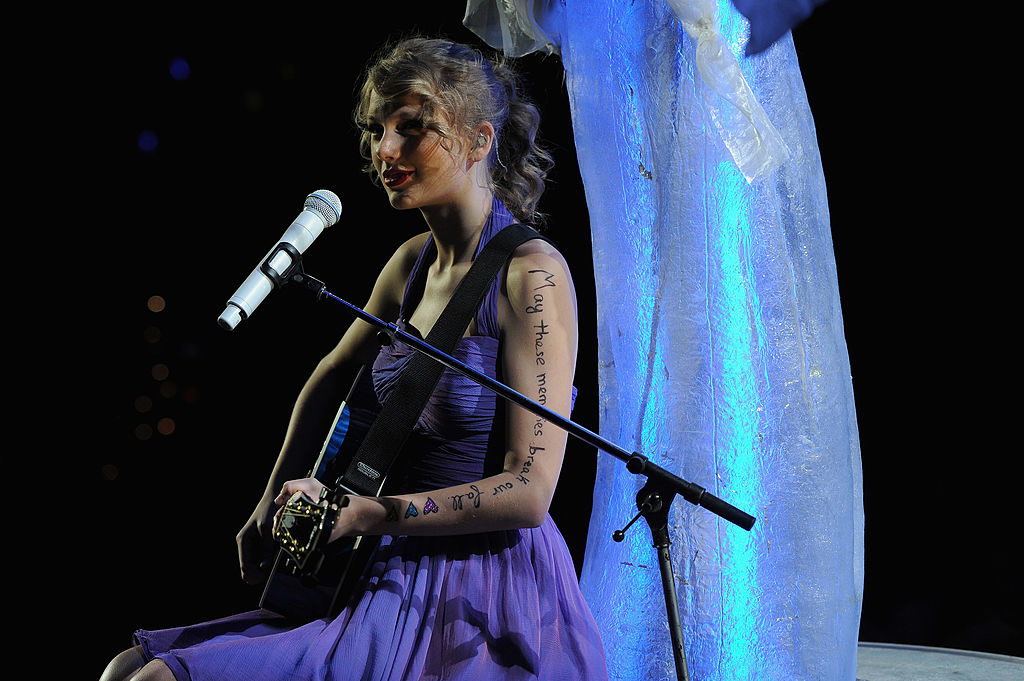 taylor playing guitar on stage