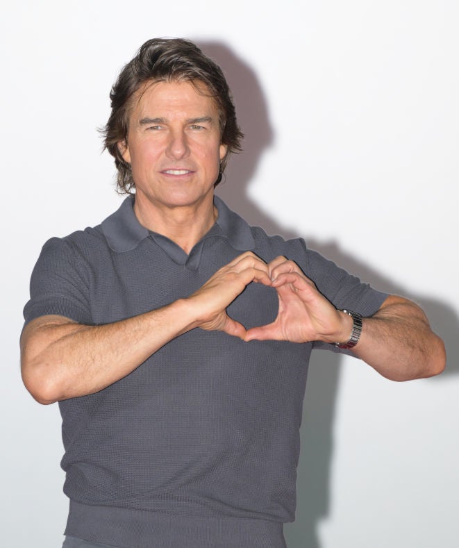 Tom making a heart with his hands
