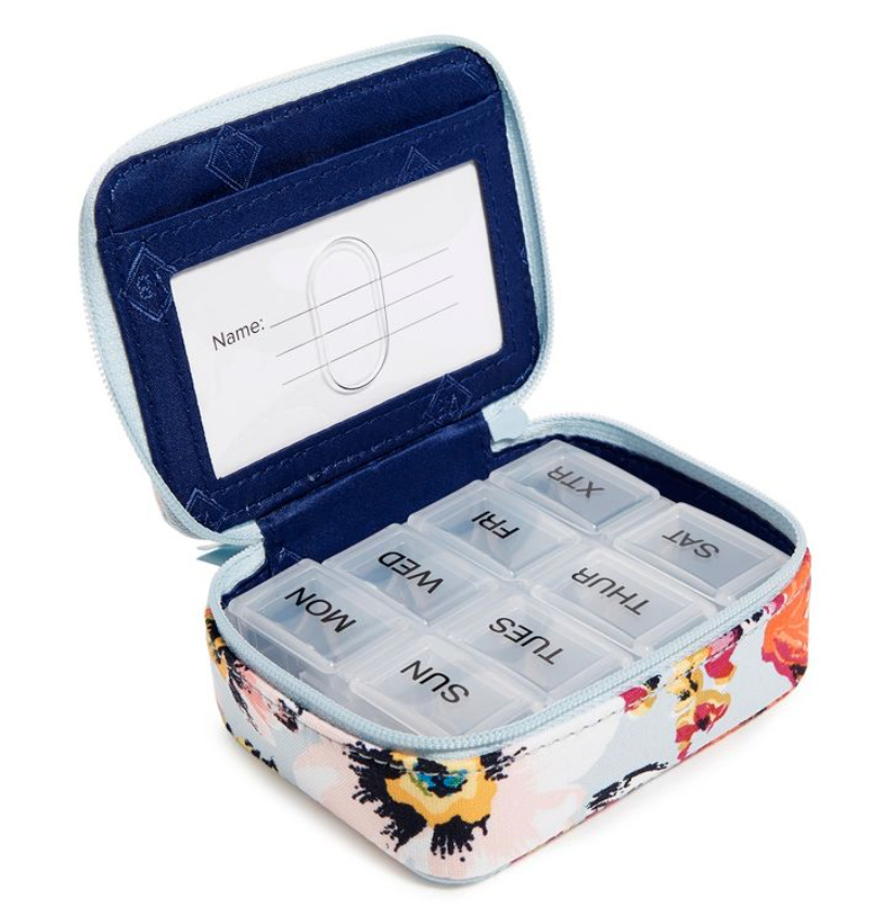 an open pill case with a floral pattern