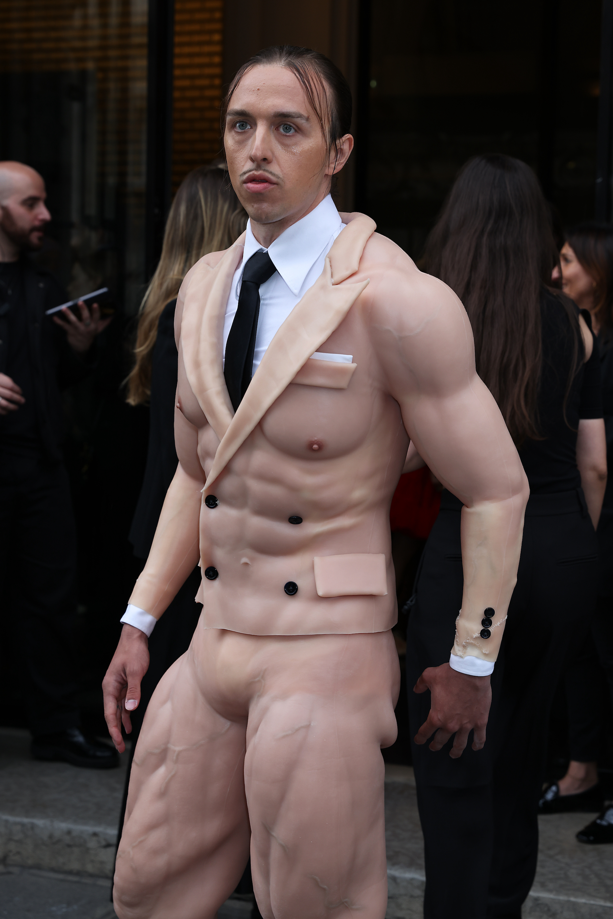 Closeup of Tommy Cash in a muscle suit