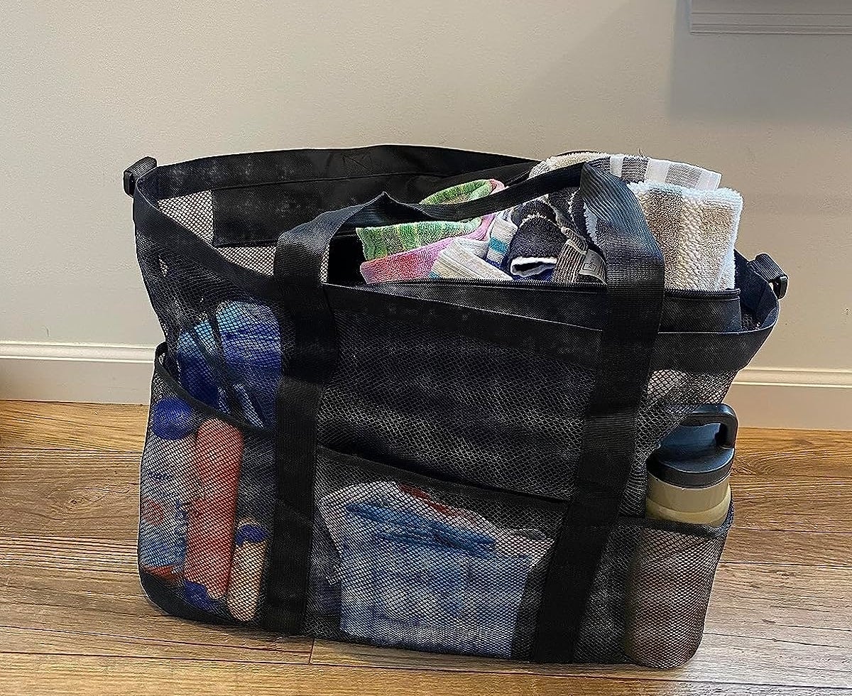 Reviewer image of the black beach bag filled with things