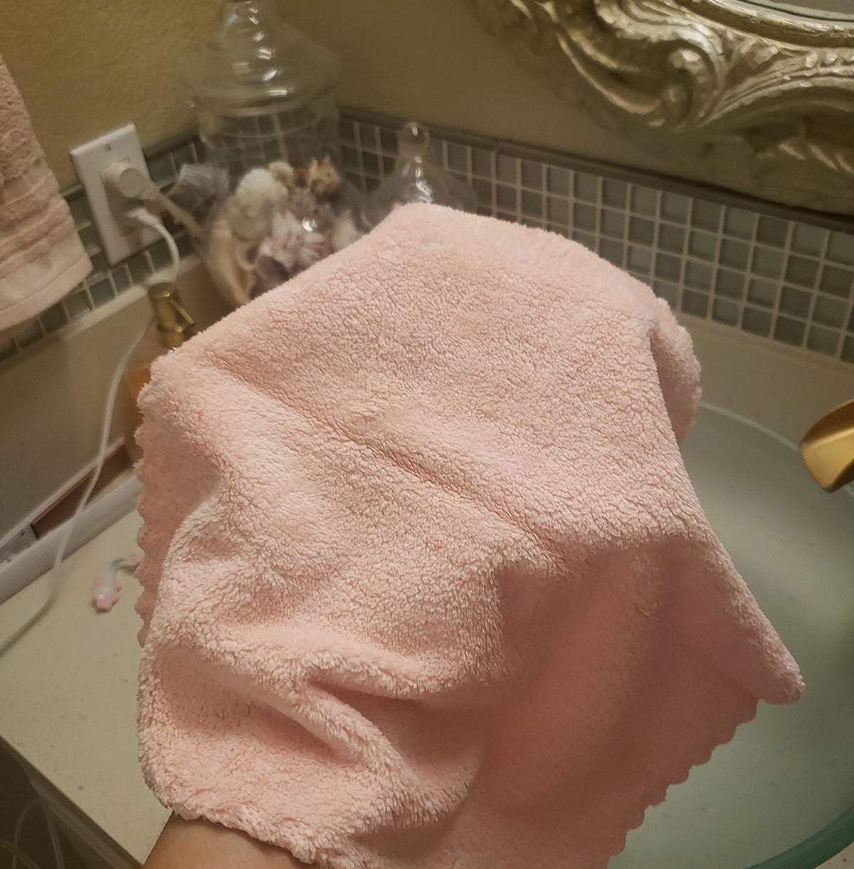 Reviewer holding the pink microfiber cloth