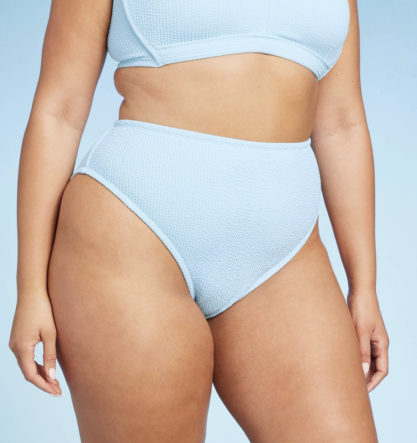 model wearing light blue mid-rise bikini bottom