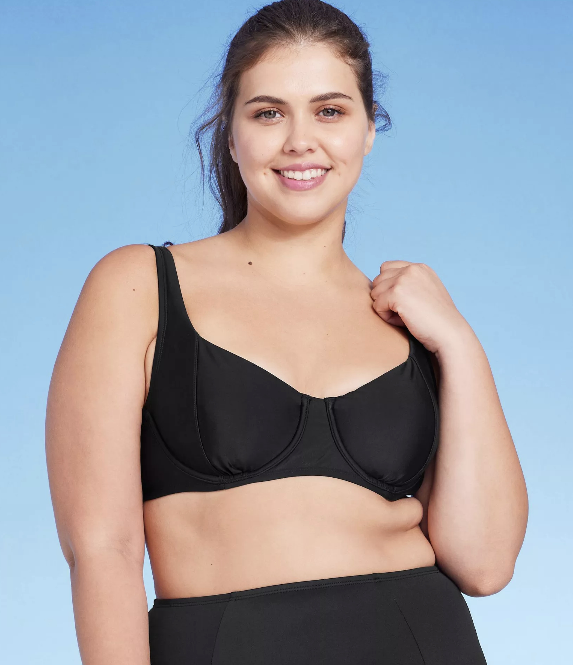 model wearing black underwire swim top with matching high-rise bottoms