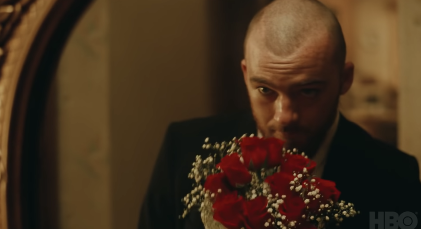 Close-up of Angus holding a bouquet of roses
