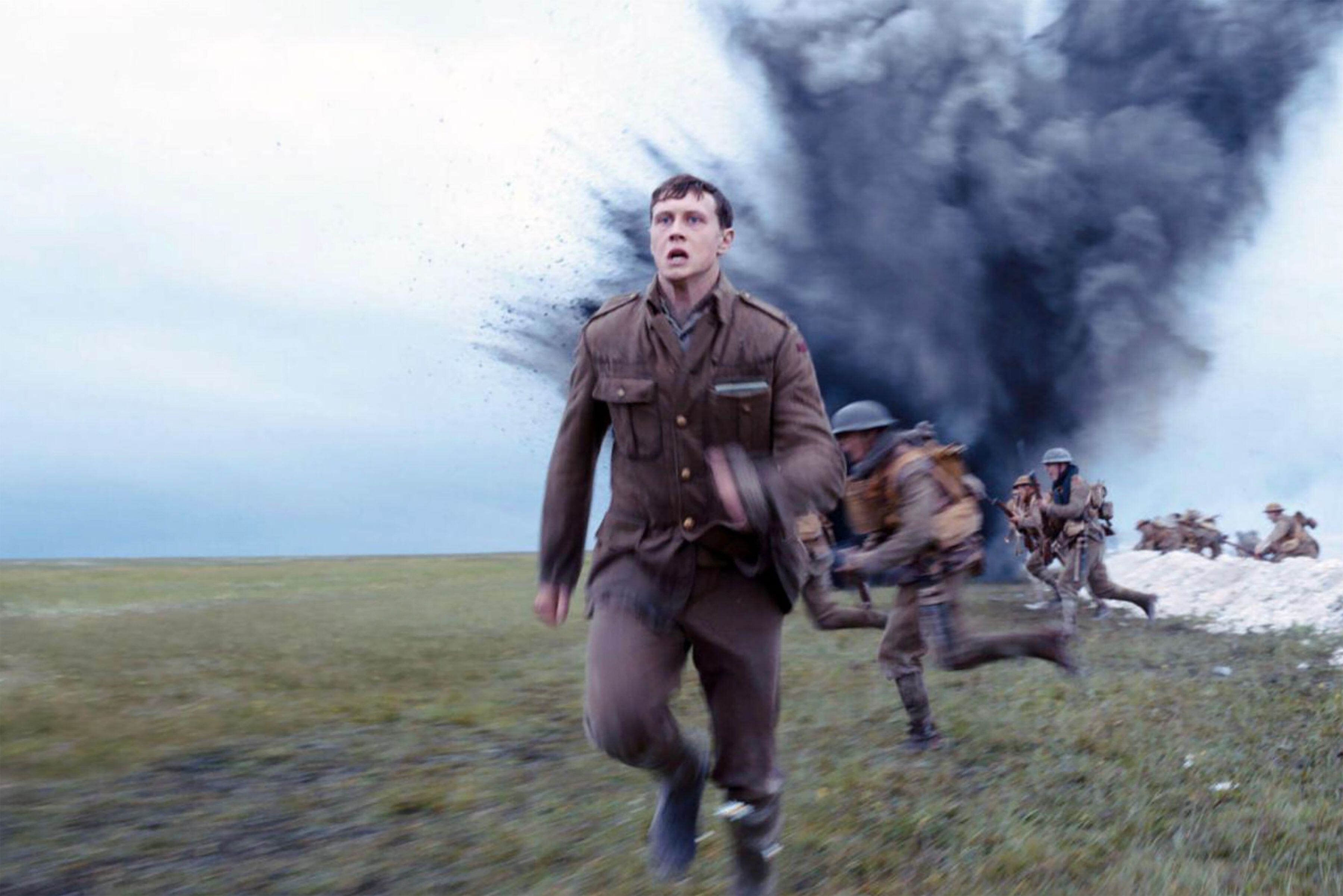 A British World War I soldier sprints across a field in the midst of explosive combat