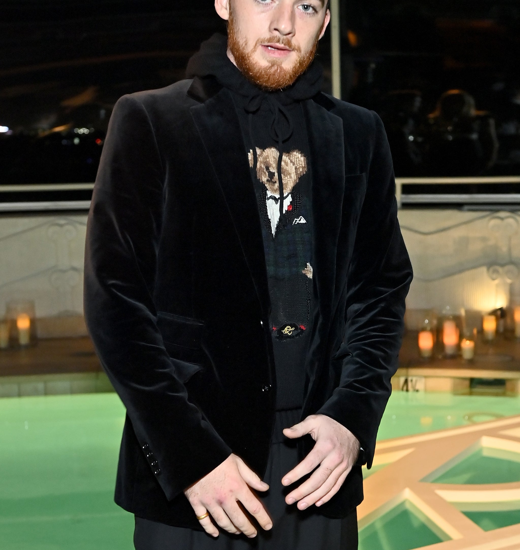Close-up of Angus in a velour suit jacket and hoodie