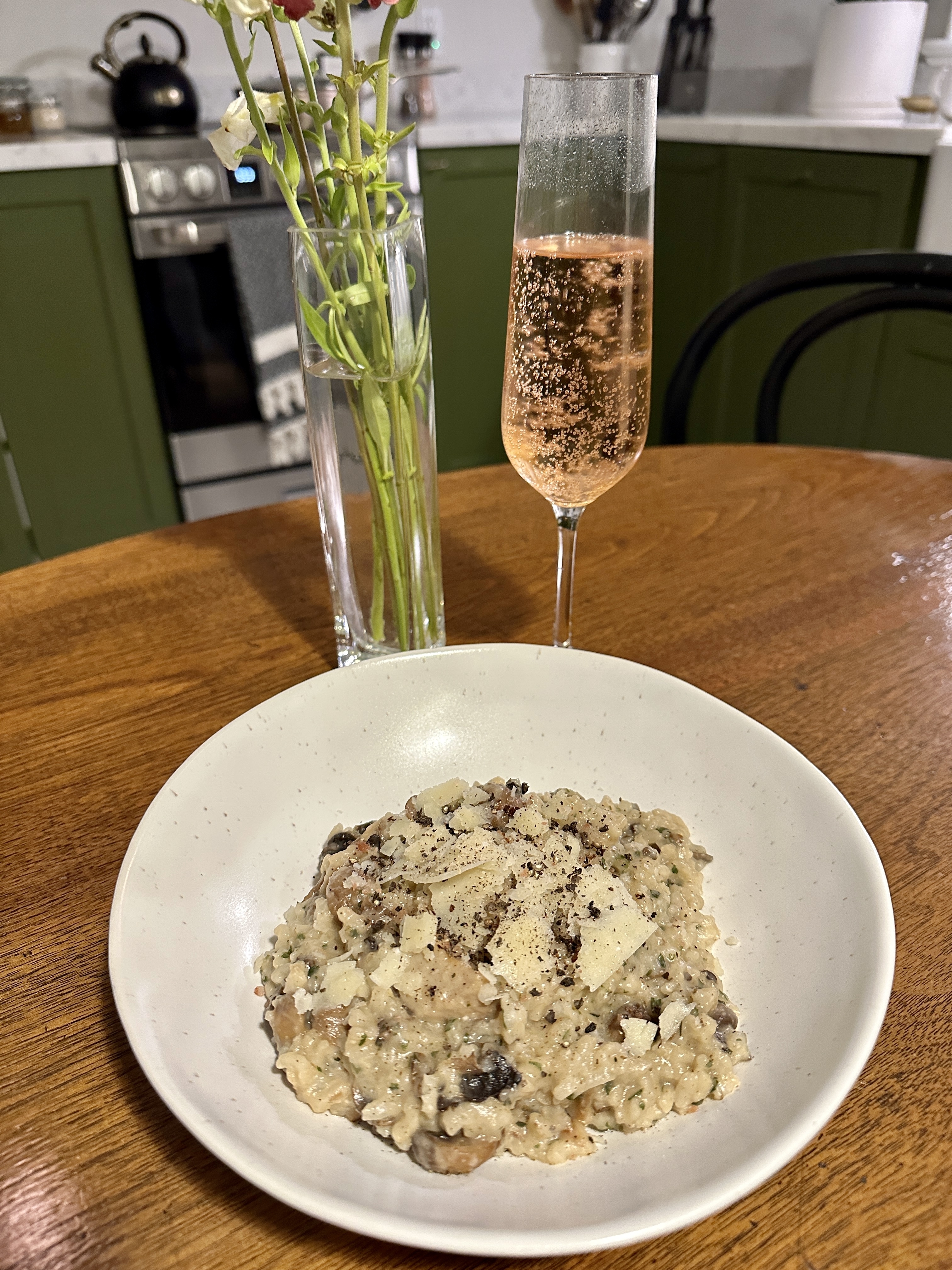 A bowl of pasta with a glass of alcohol free wine