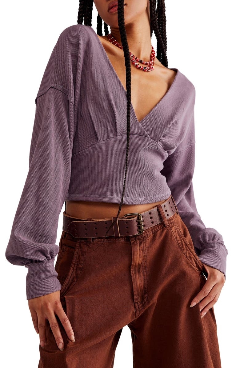 model in purple long sleeve crop top with a deep v