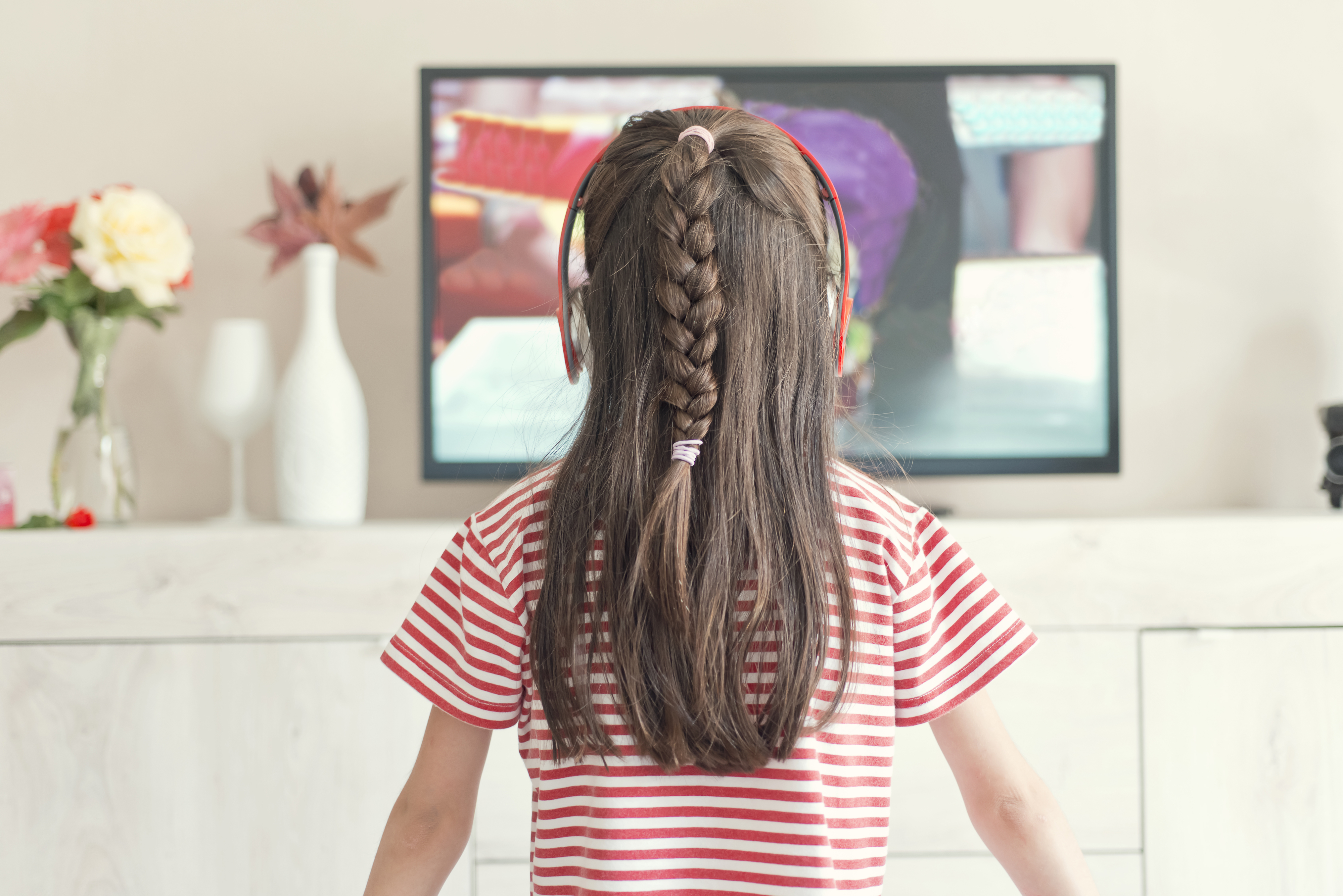 A little girl watching TV