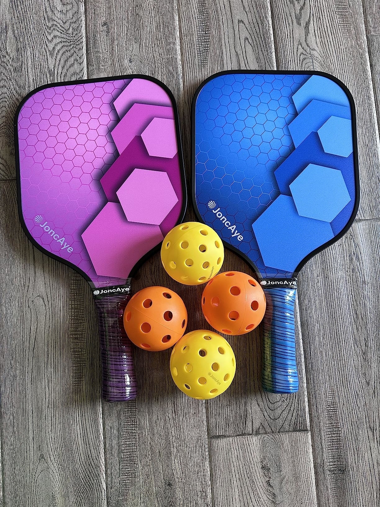 a reviewer&#x27;s image of two paddles and four balls
