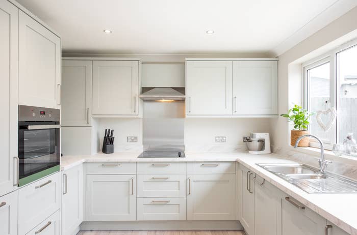 An all-white, bare kitchen