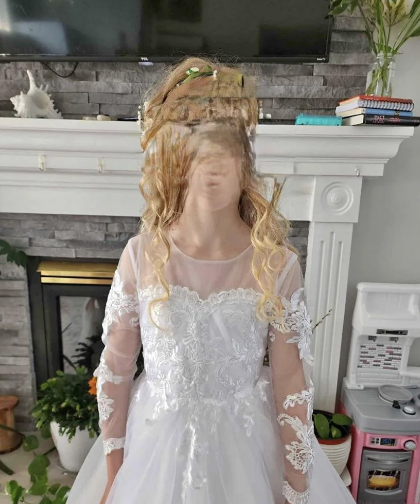 A person posing in a white dress with their face disturbingly distorted