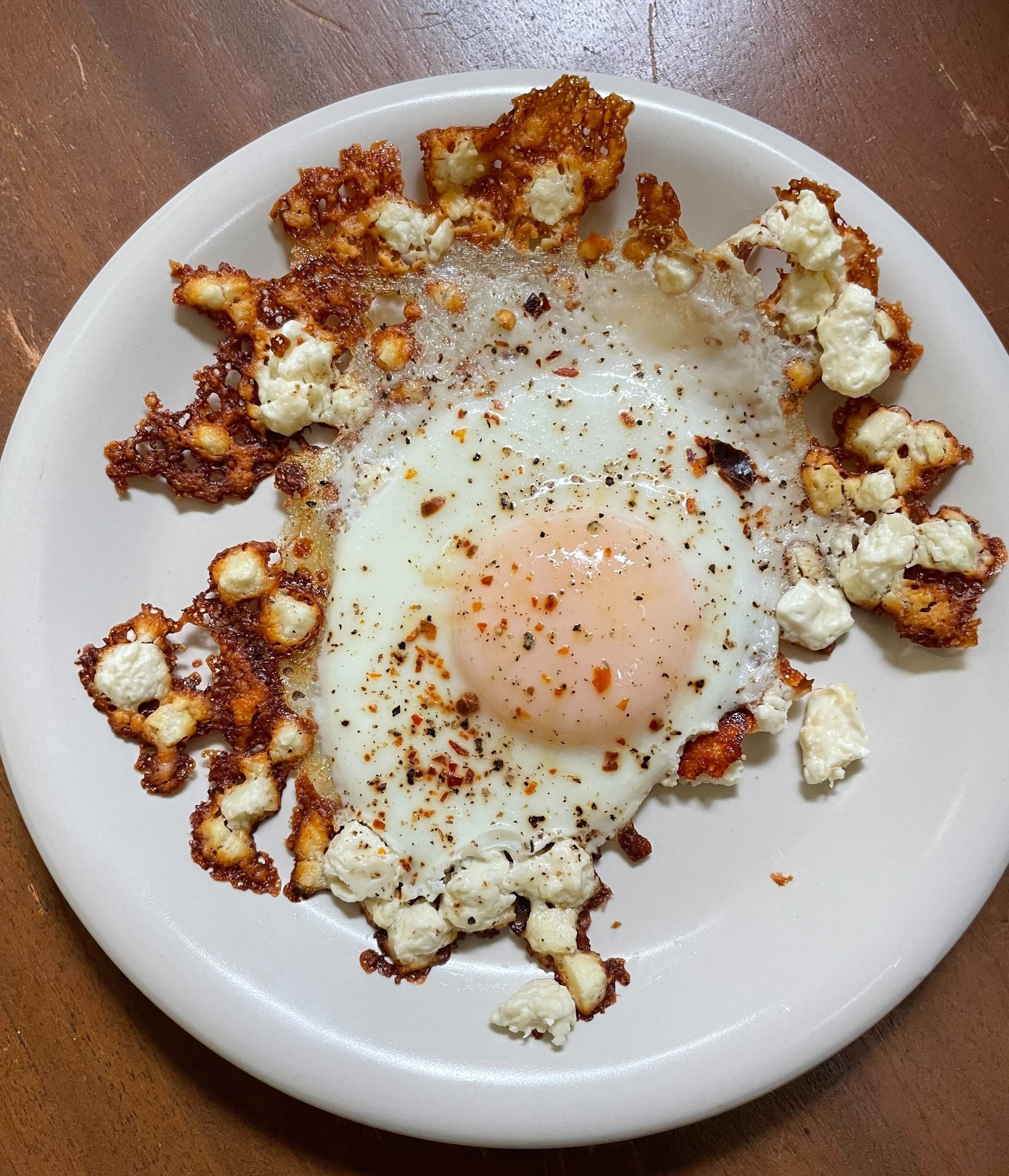 A beautiful, gorgeous, spectacular feta-fried egg is on a plate in all its glory