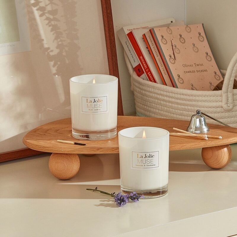 the lavender eucalyptus and jasmin scented candles on a wood tray