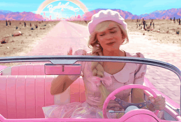 Barbie driving and singing in her pink convertible