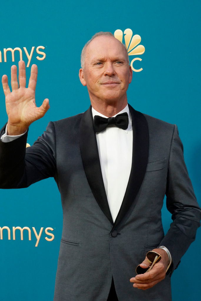 Close-up of Michael waving in a suit and bow tie at a media event