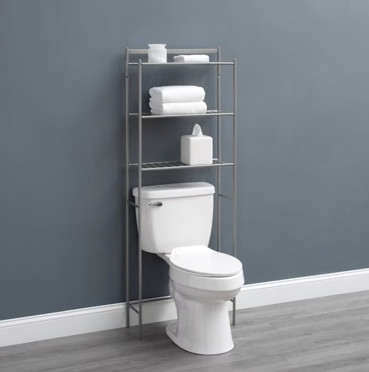 metal stand above toilet with tissues and towels on shelves