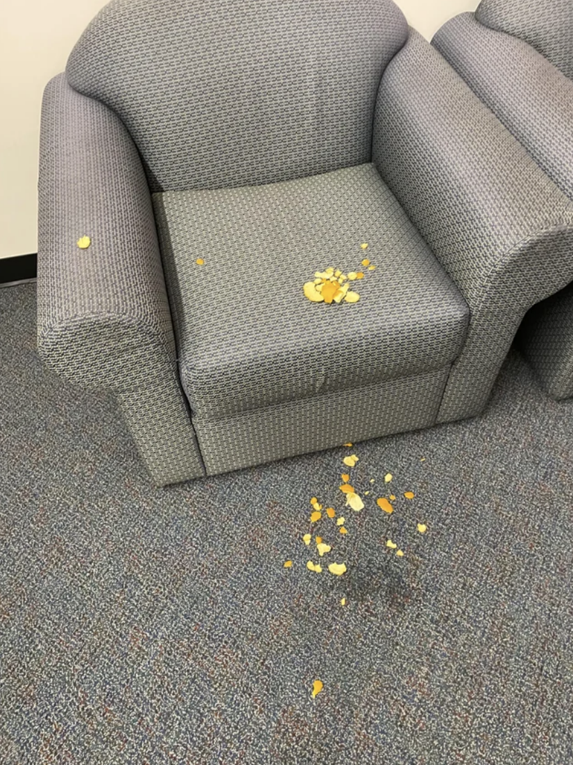 The chair and floor are covered with spilled chips