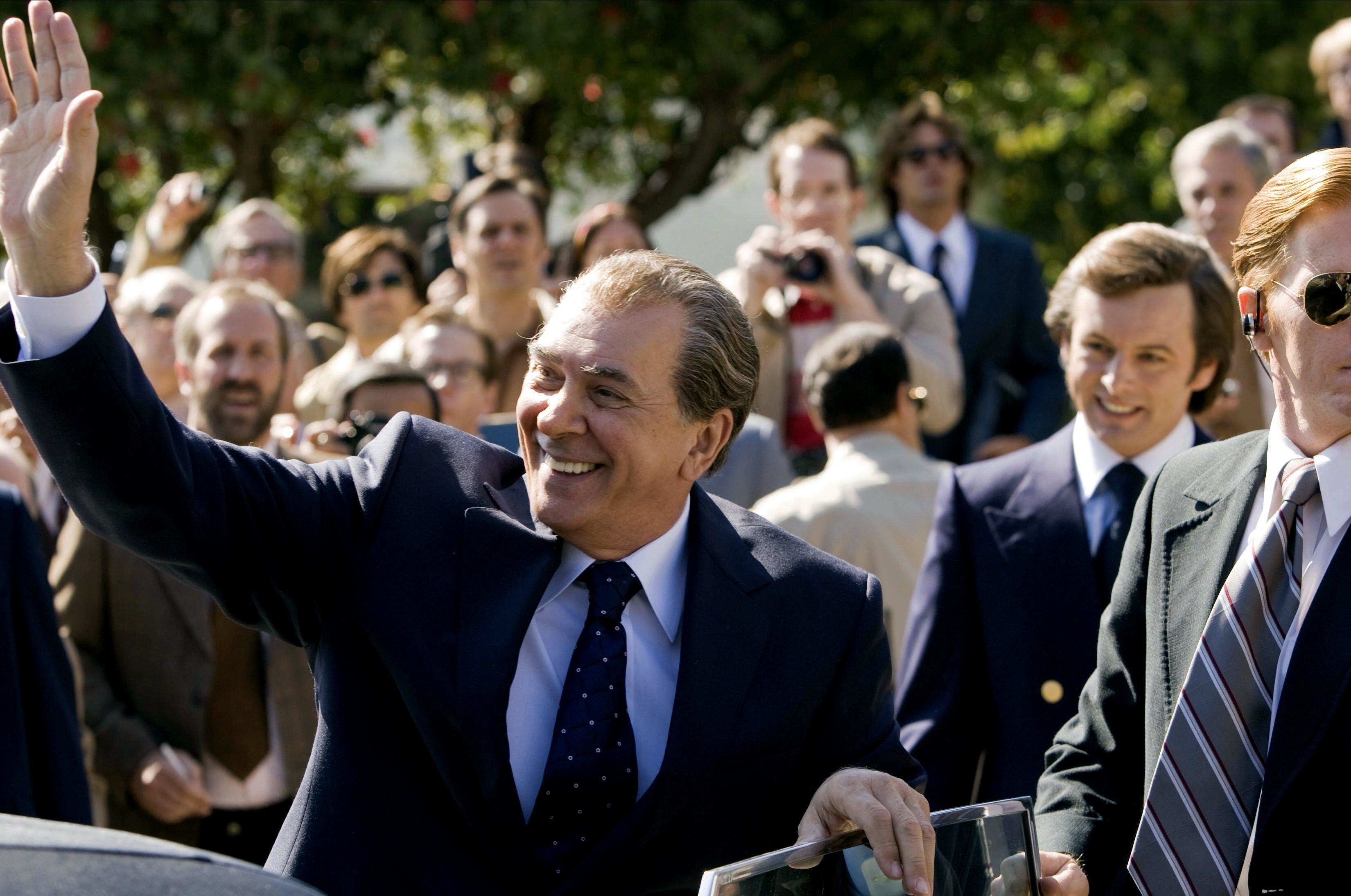 Frank as Nixon waving