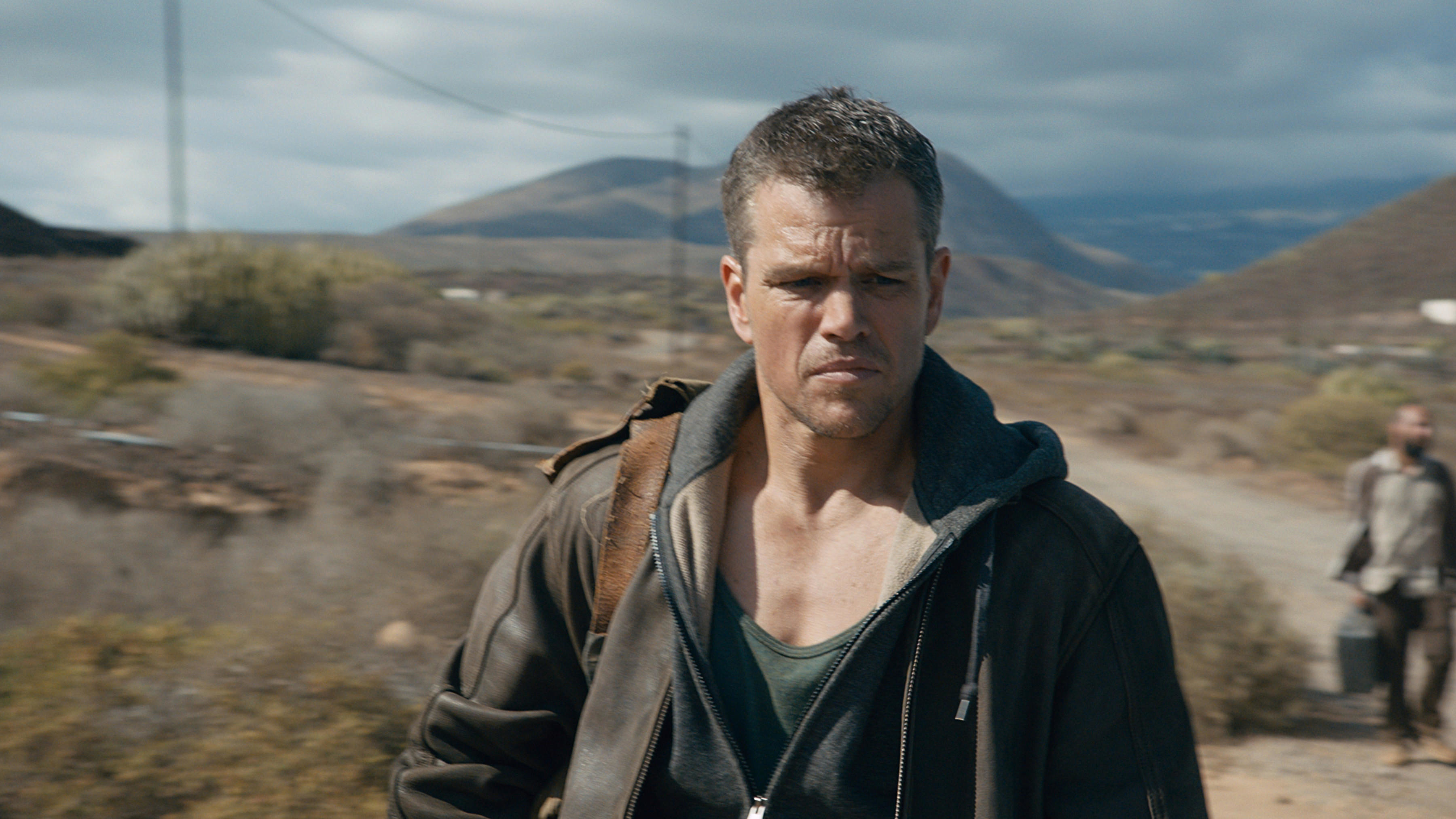 Close-up of Matt in a jacket amid a rugged outdoor scene