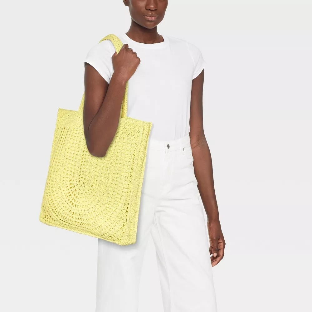 a model holding the yellow bag