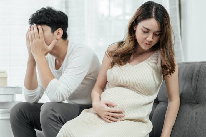 Pregnant couple appears visibly stressed