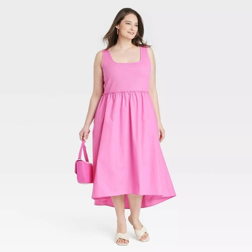 a model wearing the dress in pink with a matching pink purse