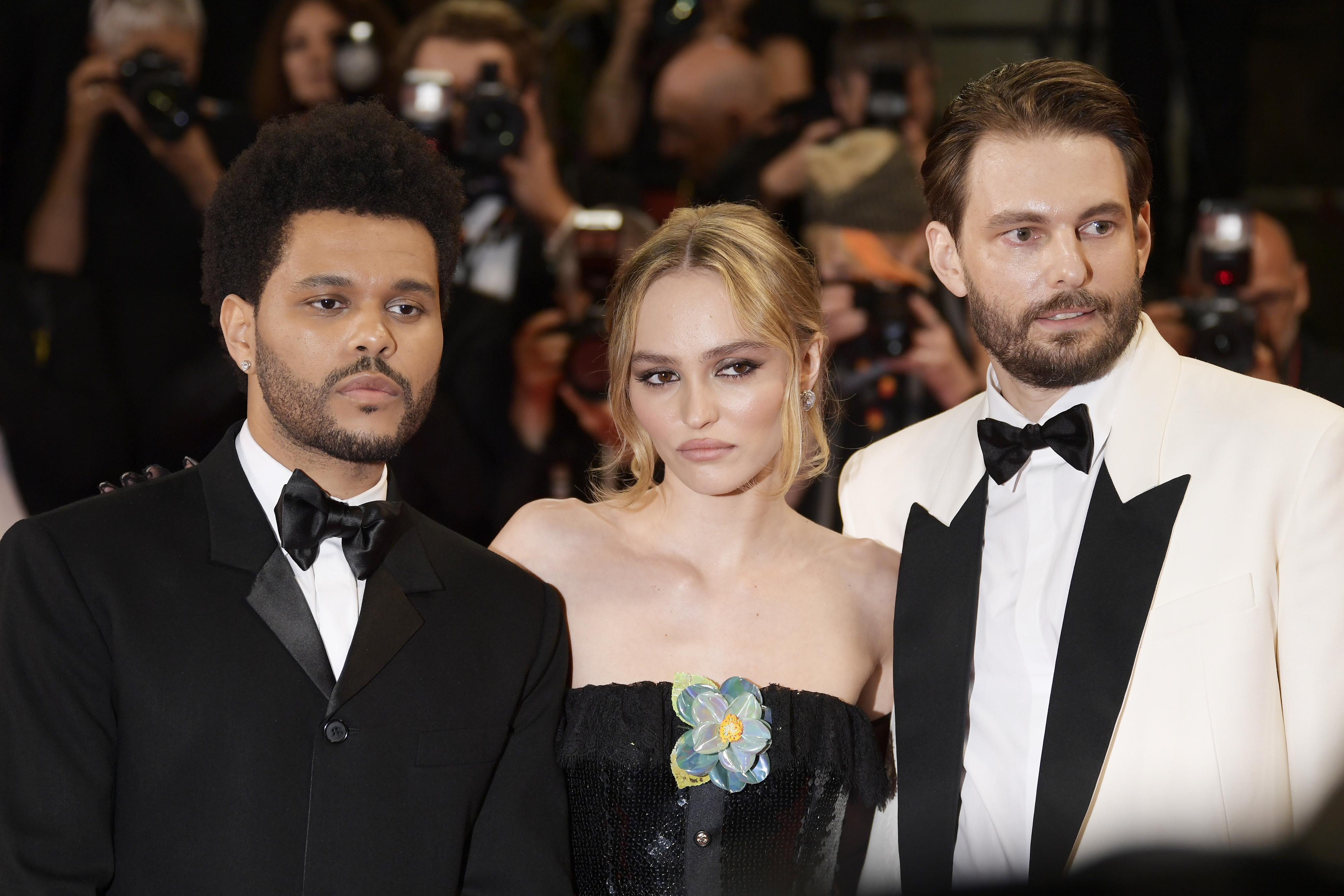 A close-up of Abel, Lily-Rose, and Sam at a media event