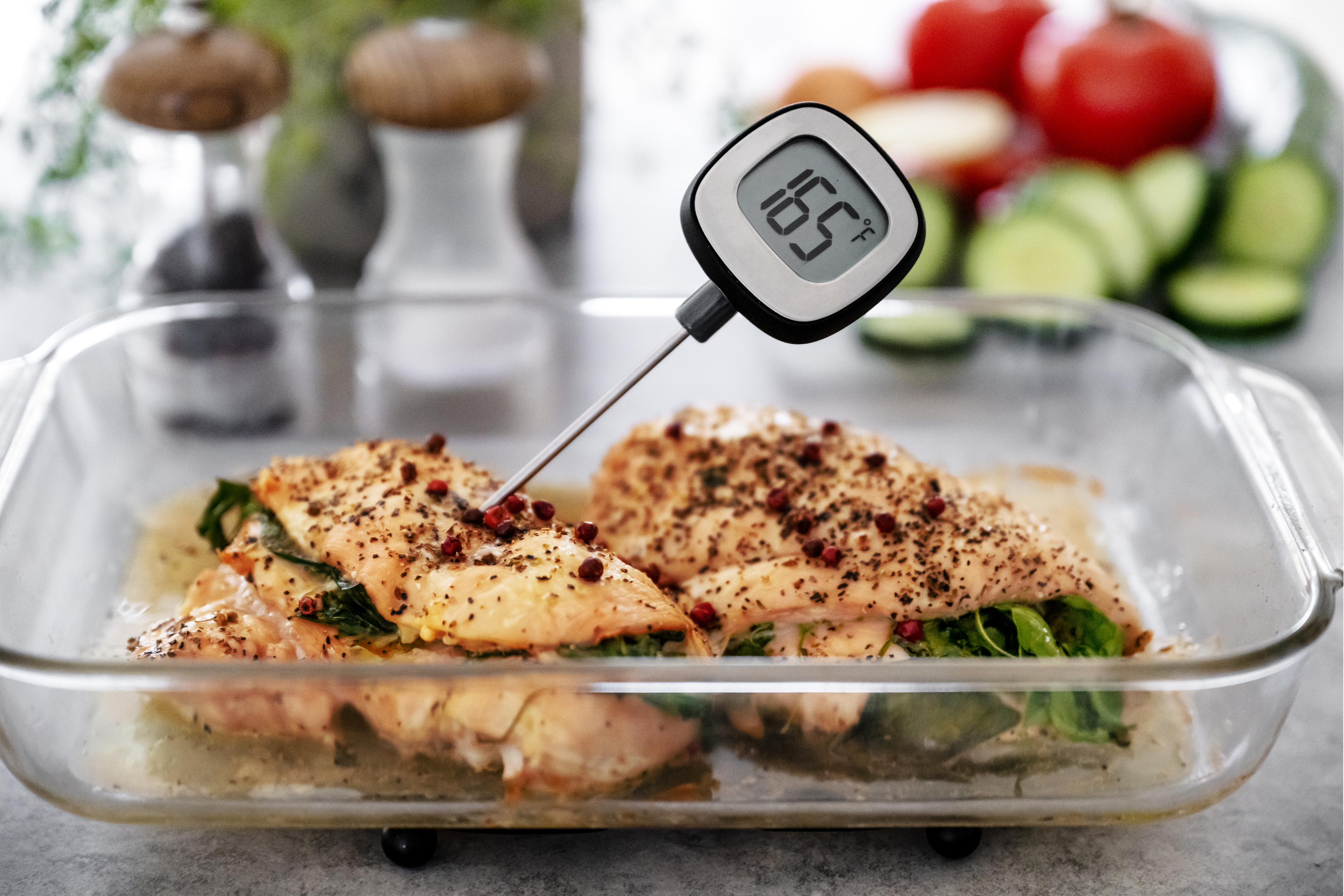 a meat thermometer reading the temperature of cooked chicken